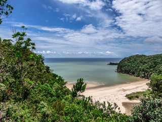 Fototapeta na wymiar A hidden beach in Borneo, Bako National Park, Malaysia. Seen from a high situated viewing point. Hidden paradise. Beautiful destination for holidays. Beach surrounded by forest and cliffs.