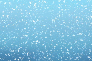 Fototapeta na wymiar Snow falls on winter blue sky background