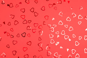 Heart-shaped red confetti on vibrant background. Festive and celebration, Valentine's Day concept. Love symbols.