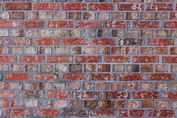 red brick wall texture grunge background with vignetted corners, may use to interior design. Old orange brick.