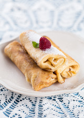 Thin homemade pancakes with raspberry