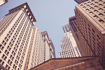 Fototapeta na wymiar Looking up at Wall Street buildings, color toned picture, New York, USA.