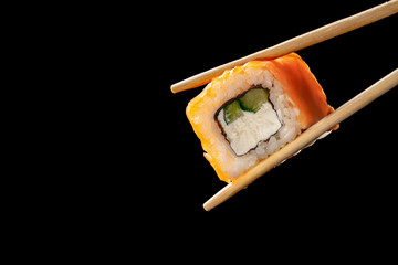 sushi rolls with chopsticks on black background