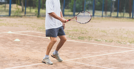Man in sportswear standing on tennis court and flirting, sports hobby