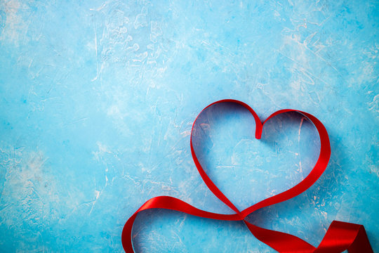 Valentines Day background with red heart. Heart shape from ribbons. Happy Valentine Day