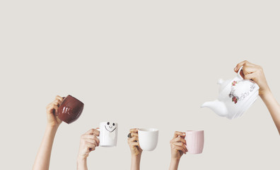 Hands holding different cup on isolated background