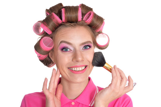 portrait of young woman in hair curlers posing