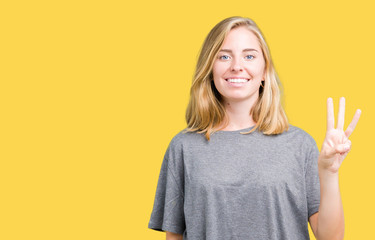 Beautiful young woman wearing oversize casual t-shirt over isolated background showing and pointing...