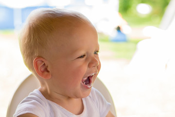 Cute toddler with dirty mouth. Portrait of the child after he has eaten yoghurt