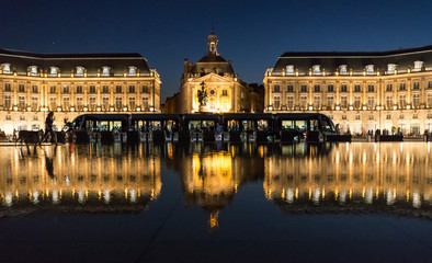 Fototapeta na wymiar Tram stoped at place de la bourse in downtown Bordeaux at night