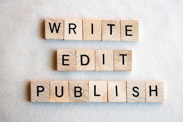 The words write edit publish written in wooden block letters on a white background. Business...