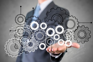 Businessman and analytics symbols on grey background