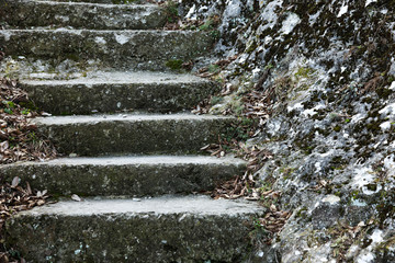 An old open outer stone staircase. Stone, cement steps of the old staircase with traces of...