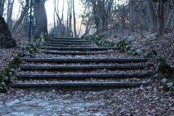 An old open outer stone staircase. Stone, cement steps of the old staircase with traces of...