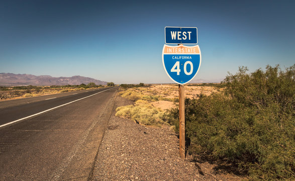 view of a california desert highway with interstate sign on a sunny day without cars