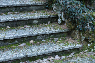 An old open outer stone staircase. Stone, cement steps of the old staircase with traces of...