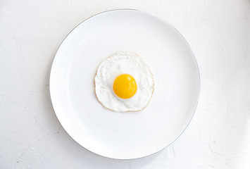 Fried egg isolated on white background, top view
