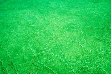 Pattern of sea waves toned in electric green