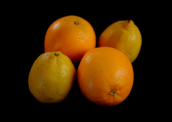lemons and oranges on a black background
