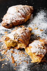 Croissants with almonds on the black background