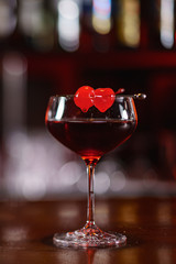 cocktail in the bar with orange zest and cherry