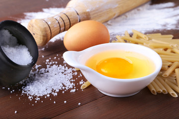egg, flour, salt ingredients for pasta penne bolognese. Cooking concept. Top view.