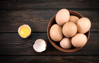 A plate of yellow eggs on a wooden background