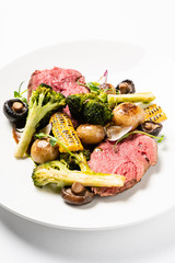 Spicy Beef Slices Meat  with broccoli, corn and mushrooms. Creative and gourmet food