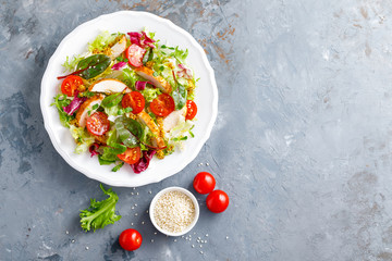 Fresh vegetable salad with grilled chicken meat, top view
