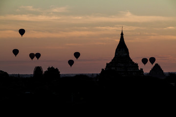 Balloons over Bagan and the skyline of its temples, Myanmar. Sulamani temple and Shwesandaw pagoda.