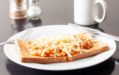 Baked beans on toast topped with grated cheese