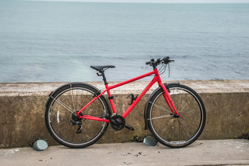 Fototapeta premium Bike leaning on a wall by the ocean