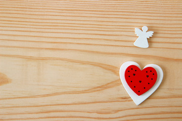 hearts and angel on wooden background