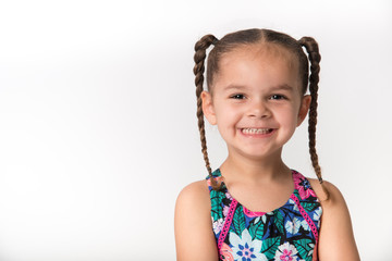 Mixed race preschooler with big happy smile and brown hair pigtail braids - 245045085