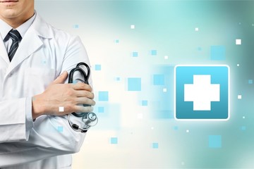 Male doctor with stethoscope on blurred hospital background