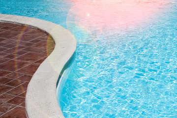 Stylishly interesting water slide in the pool near the sea on nature background