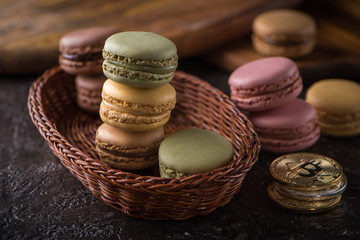 Columns with macaroons on wicker basket background with bitcoins