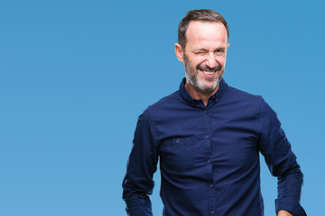 Middle age hoary senior man over isolated background winking looking at the camera with sexy...