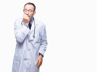 Middle age senior hoary doctor man wearing medical uniform isolated background looking stressed and nervous with hands on mouth biting nails. Anxiety problem.