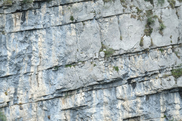 Close up Dolomite rock textures and layer in different colours. Grey, dark grey, white, and iron brown. Trentino, Northern Italy Europe.