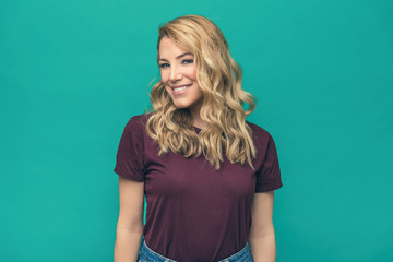 Portrait of smiling woman on blue background.