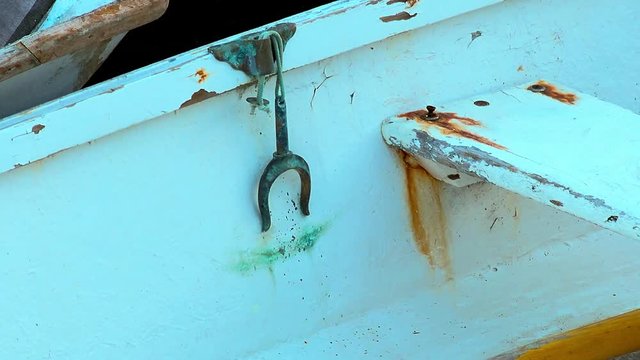 Beautiful shot of inside colorful and weathered row boat with rusty oarlock
