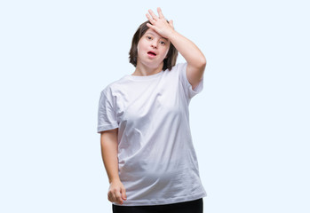 Young adult woman with down syndrome over isolated background surprised with hand on head for mistake, remember error. Forgot, bad memory concept.