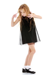 Little girl in a dress developing in the wind.