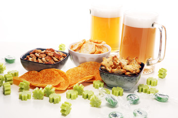 st patricks day with Chips, salty snacks, and Beer on a table. Saint celebration with lucky shamrock