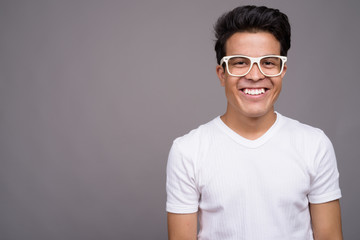 Obraz premium Portrait of young Asian man against gray background