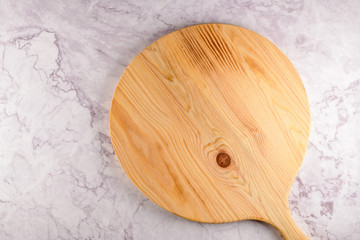 Wooden cutting board on a gray marble background
