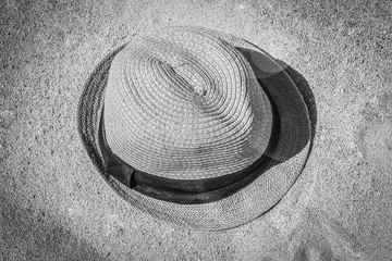 Fototapeta na wymiar Stylish beautiful hat on the sand shore of the sea background