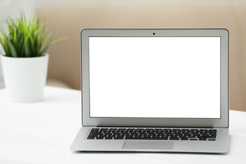 Fototapeta premium Laptop with blank screen on table indoors. Space for text