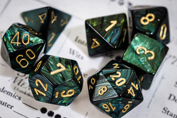 Green and black polyhedral dice